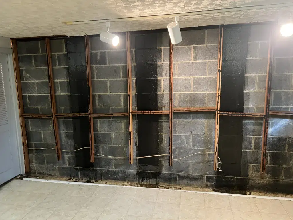 Foundation crack inspection showing vertical horizontal and stair step cracks in a new jersey basement wall | effective basement solution