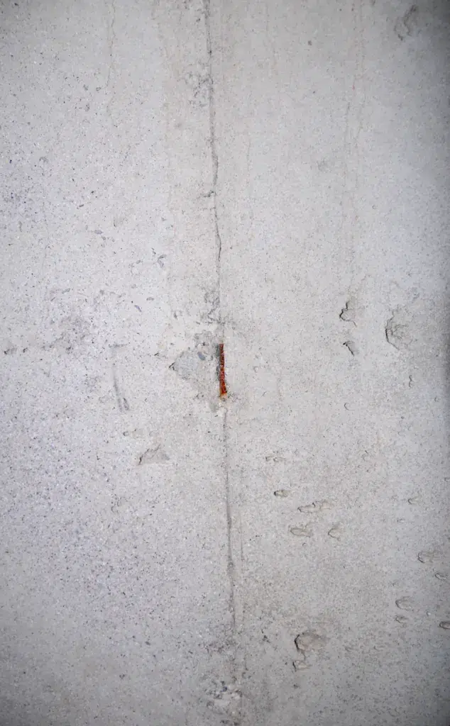 Basement waterproofing system installed along poured concrete foundation footing | effective basement solution